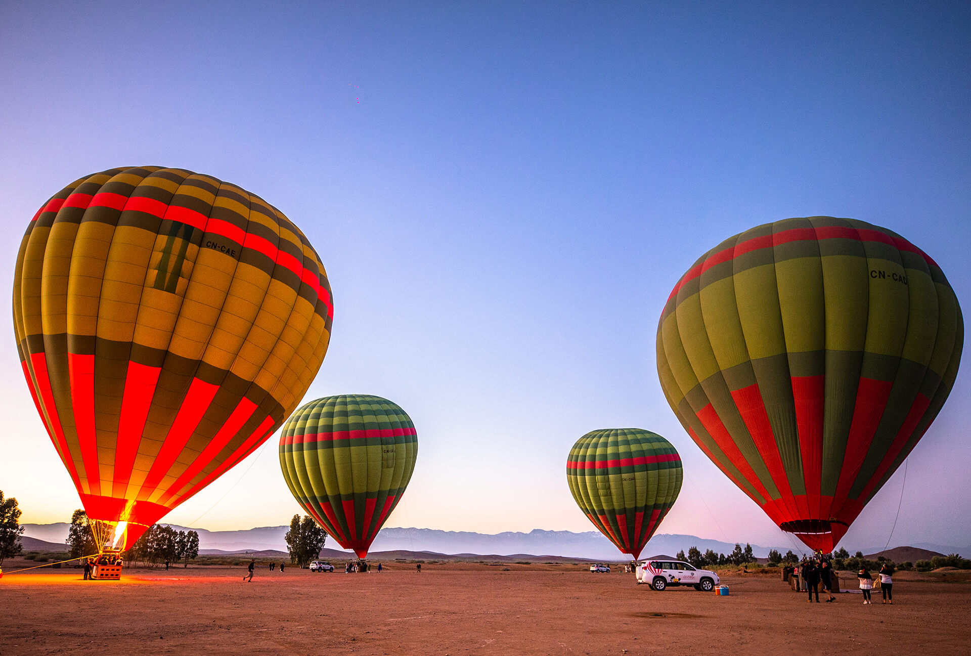 Hot air balloons flying over Marrakech at sunrise
